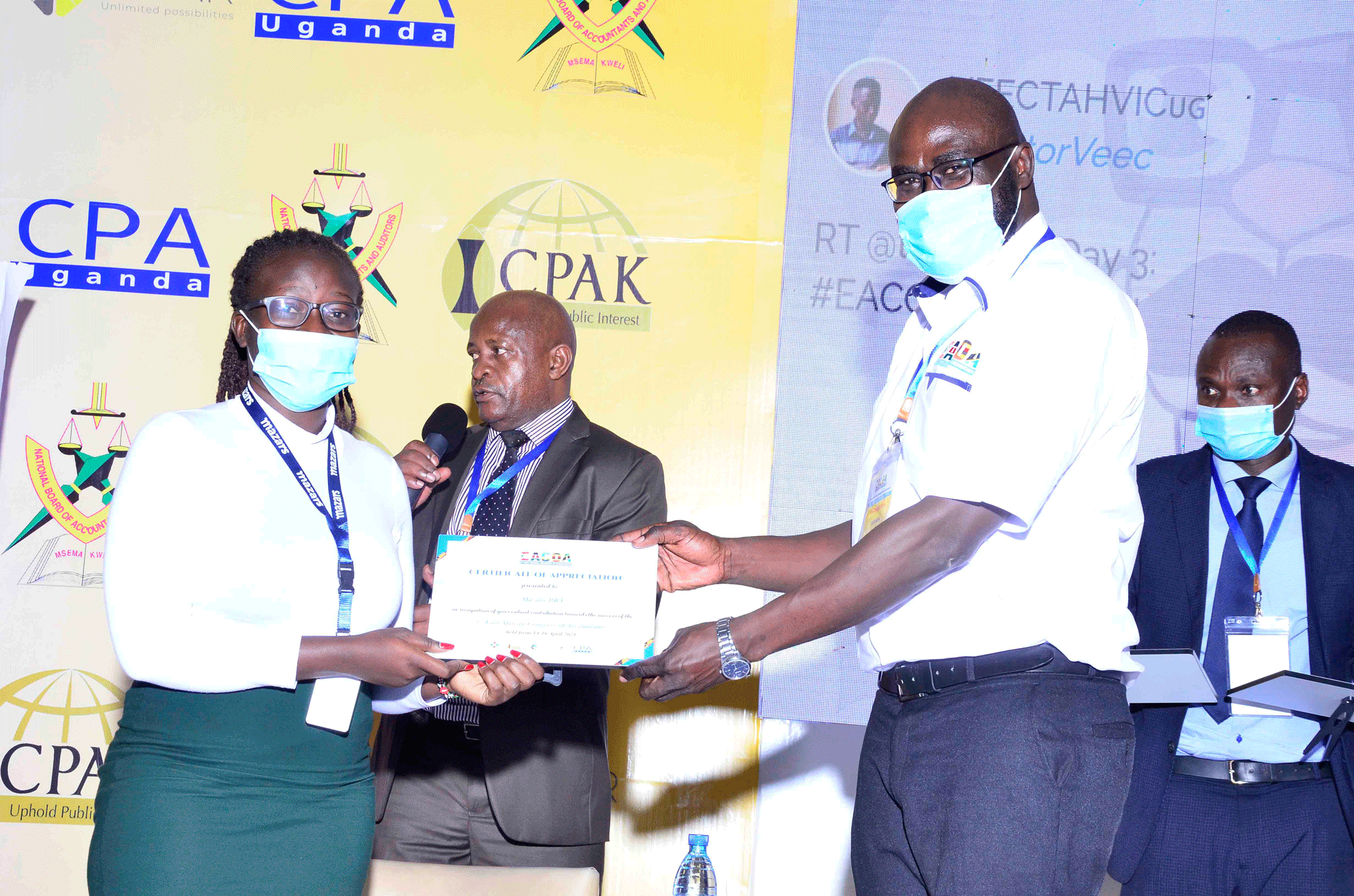 CPA Mark Omona - R - hands over Certificate to Mazars for sponsoring the EACOA