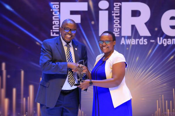 Former ICPAU President, CPA Constant Othieno Mayende (Left), honors Child's Foundation with the 2023 Reporting Under the IFRS for SMEs category.