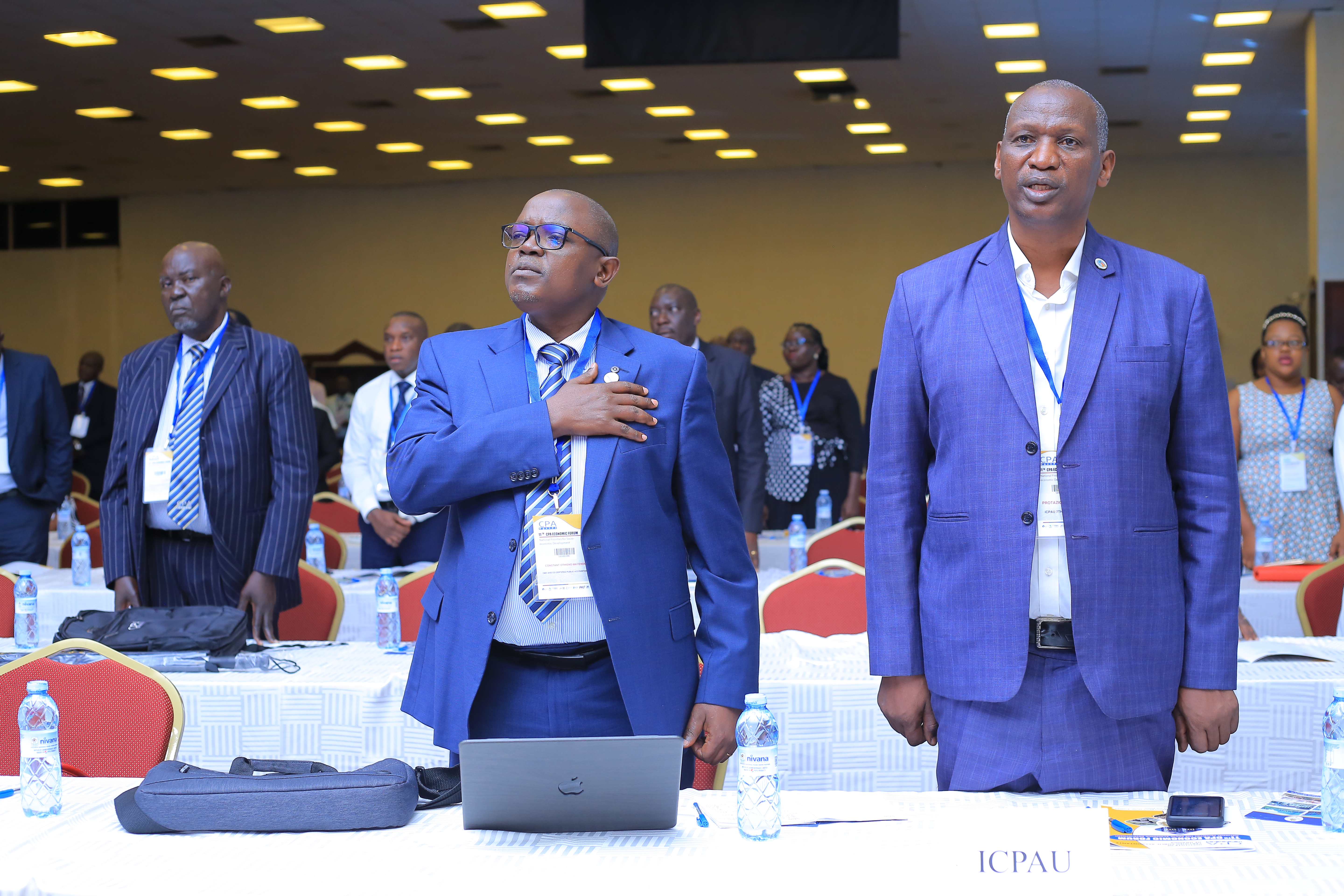 L-R; ICPAU Past presidents CPA Constant Othieno Mayende (9th President) and CPA Protazio Begumisa (7th President) singing the National & East African Anthems at the 11th CPA Economic Forum