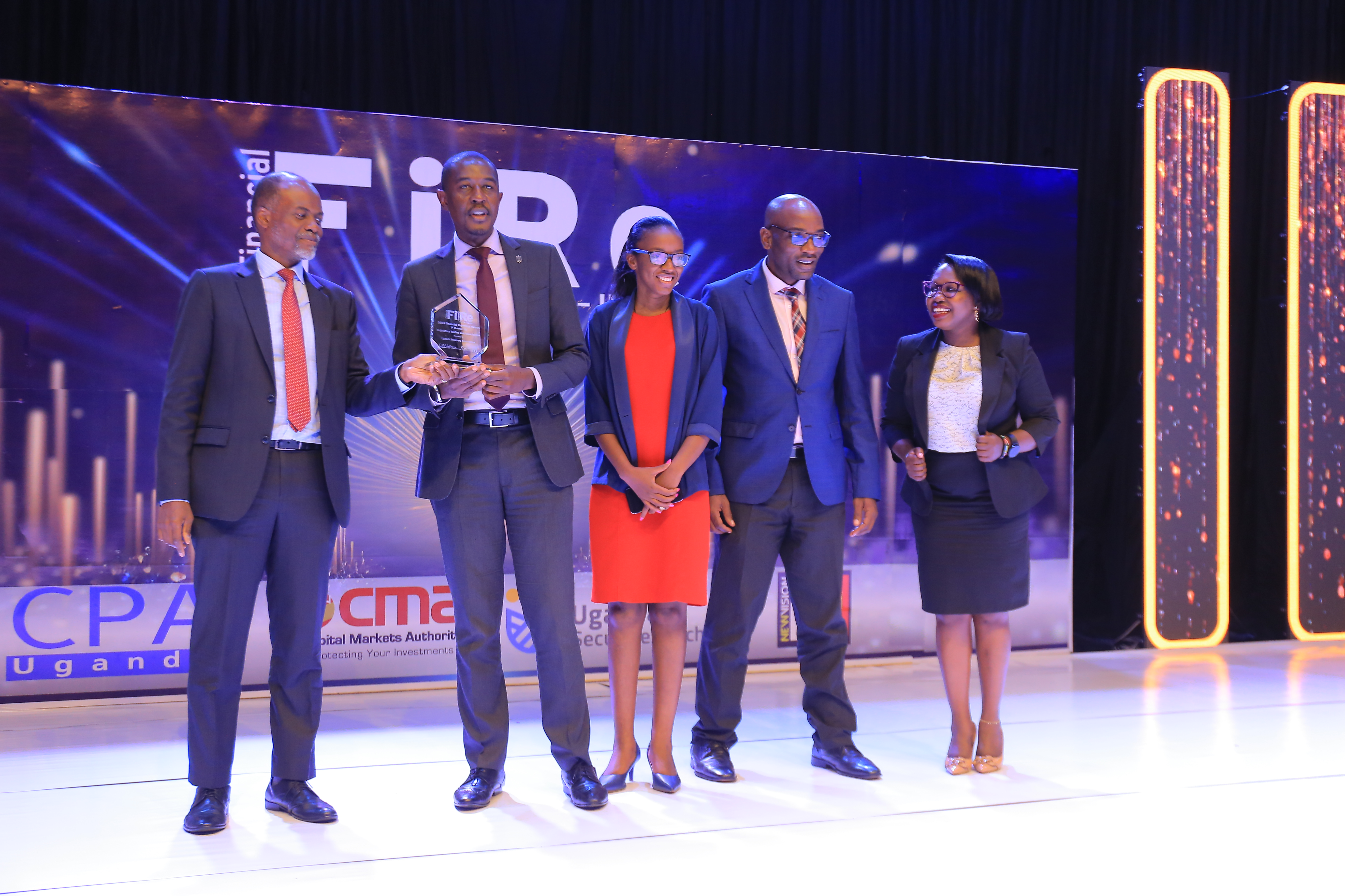 Caption -Uganda Insurers Association won 1st Runner Up in the Regulatory Bodies & Associations Category of the 2023 FiRe Awards.( Left) is Mr. Keith Kalyegira, CEO CMA handing over the award.