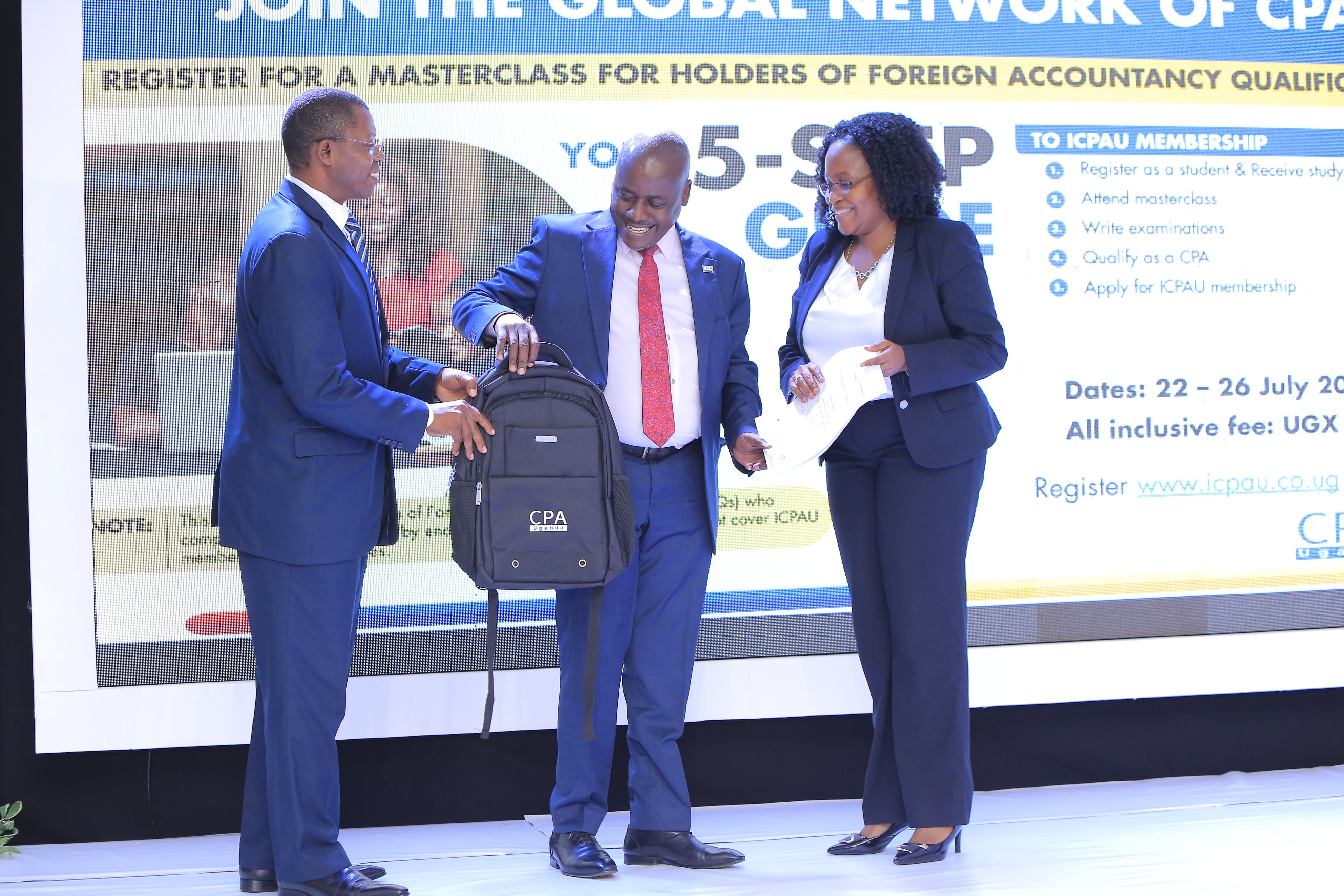 The Vice President ICPAU Council, CPA Ronald Mutumba (center) the  CEO ICPAU, CPA Derick Nkajja (left) hand over tokens of appreciation to Ms. Proscovia Nabanjja (right), one of the presenters at the 2nd C-Suite Forum.