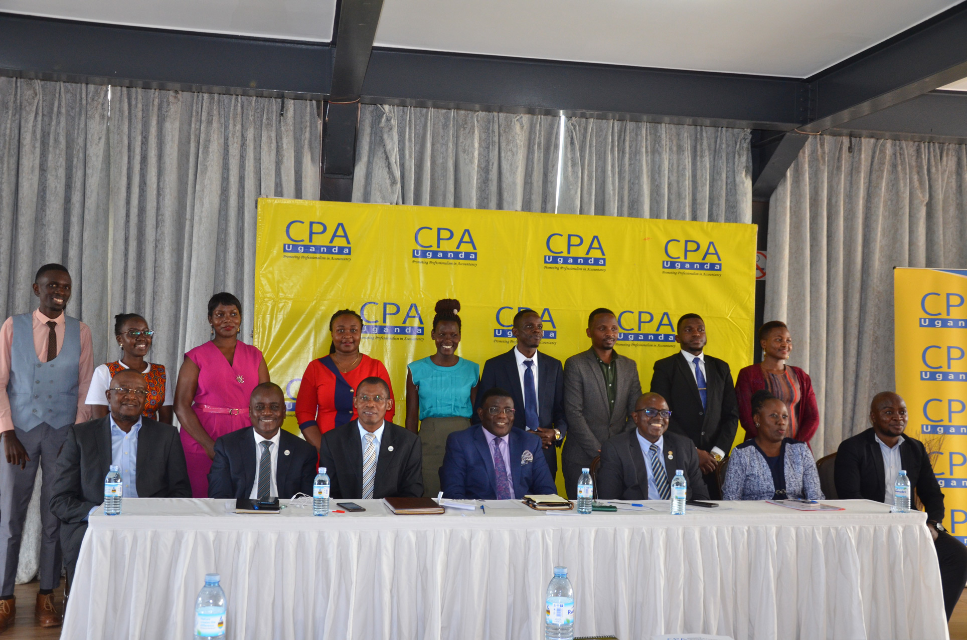 Beneficiaries of the third cohort (standing), with ICPAU Council members and Prof. Twaha Kaawaase (Chief Guest)