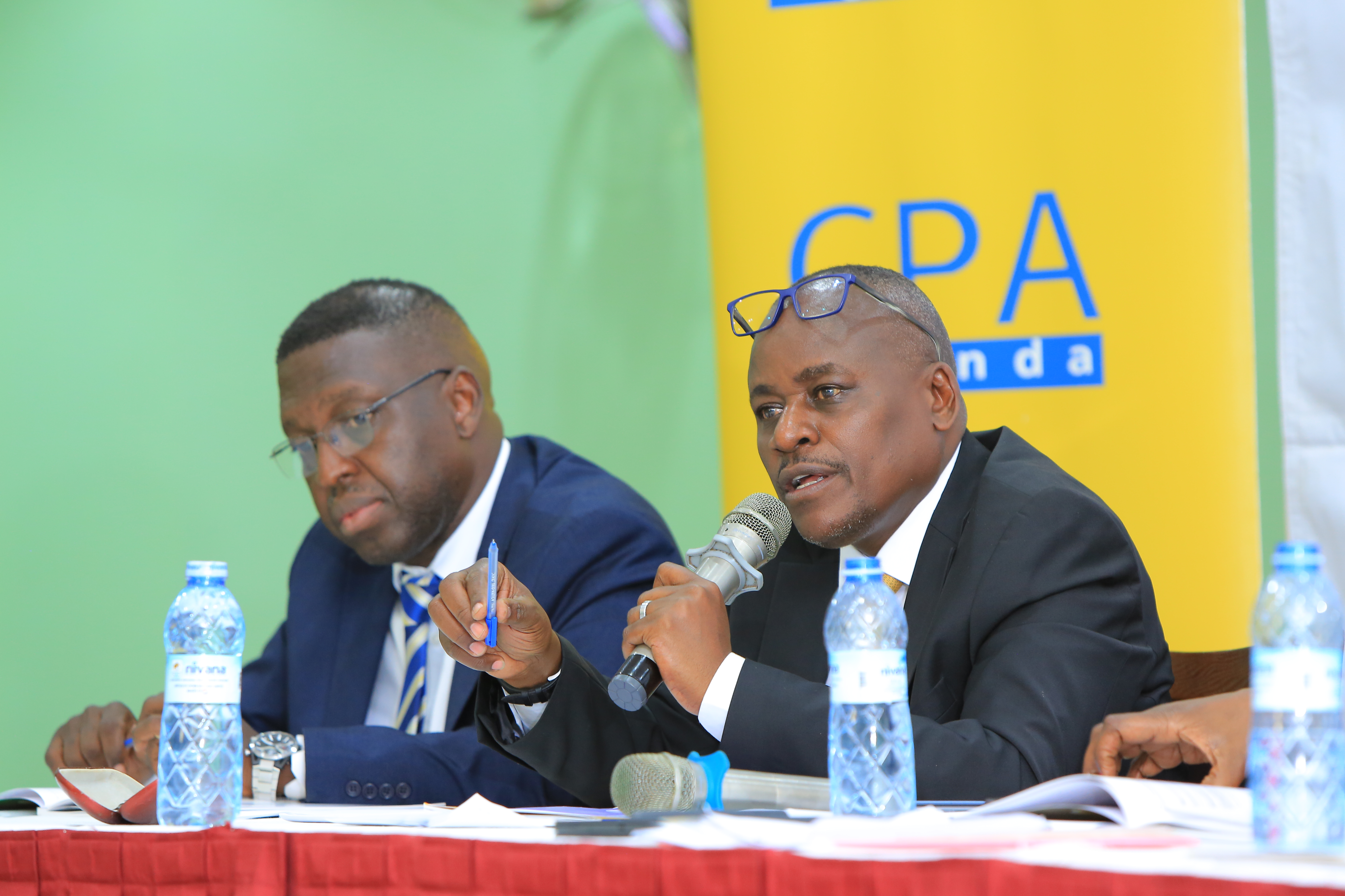 CPA Ronald Mutumba - Member, ICPAU Council addressing members at the 31st AGM. Left is CPA Timothy David Ediomu - Member, ICPAU Council.