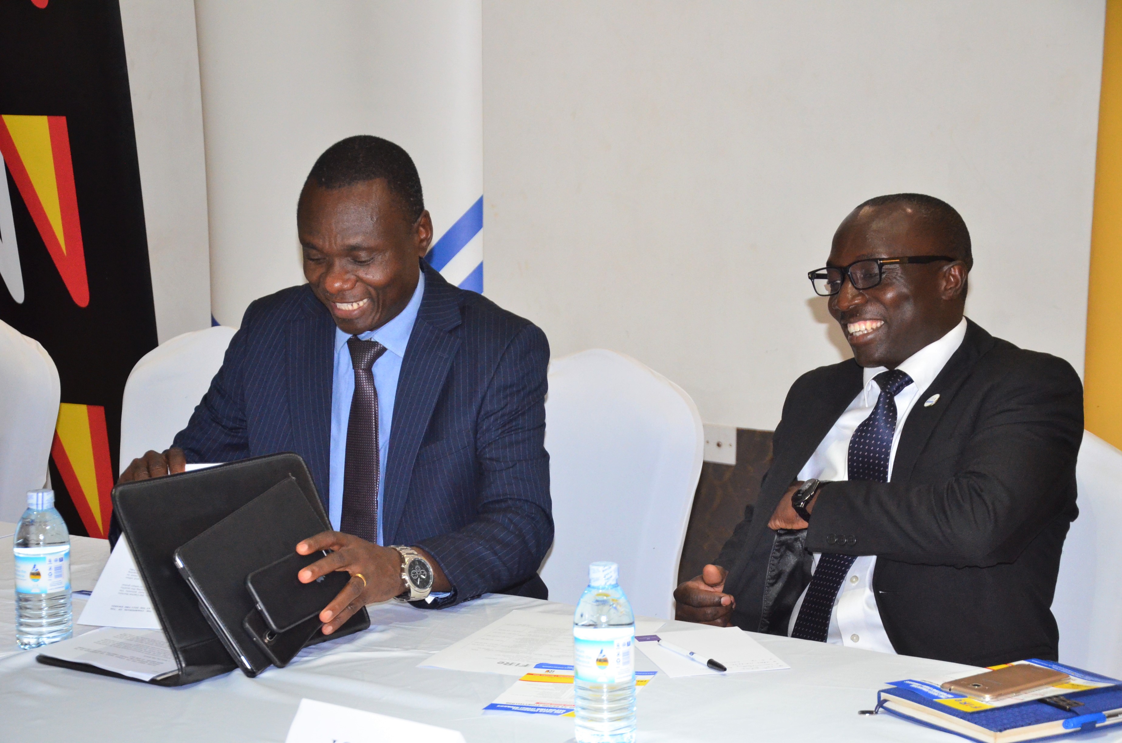 CPA Stephen Ineget, the chairman of the FiRe awards committee and CPA Charles Lutimba, Head of Standards at ICPAU share a light moments at the event