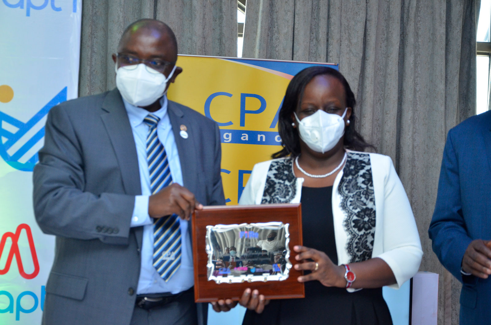 Centenary Bank's CPA Patricia Mu ... rom CPA Constant Mayende (L)