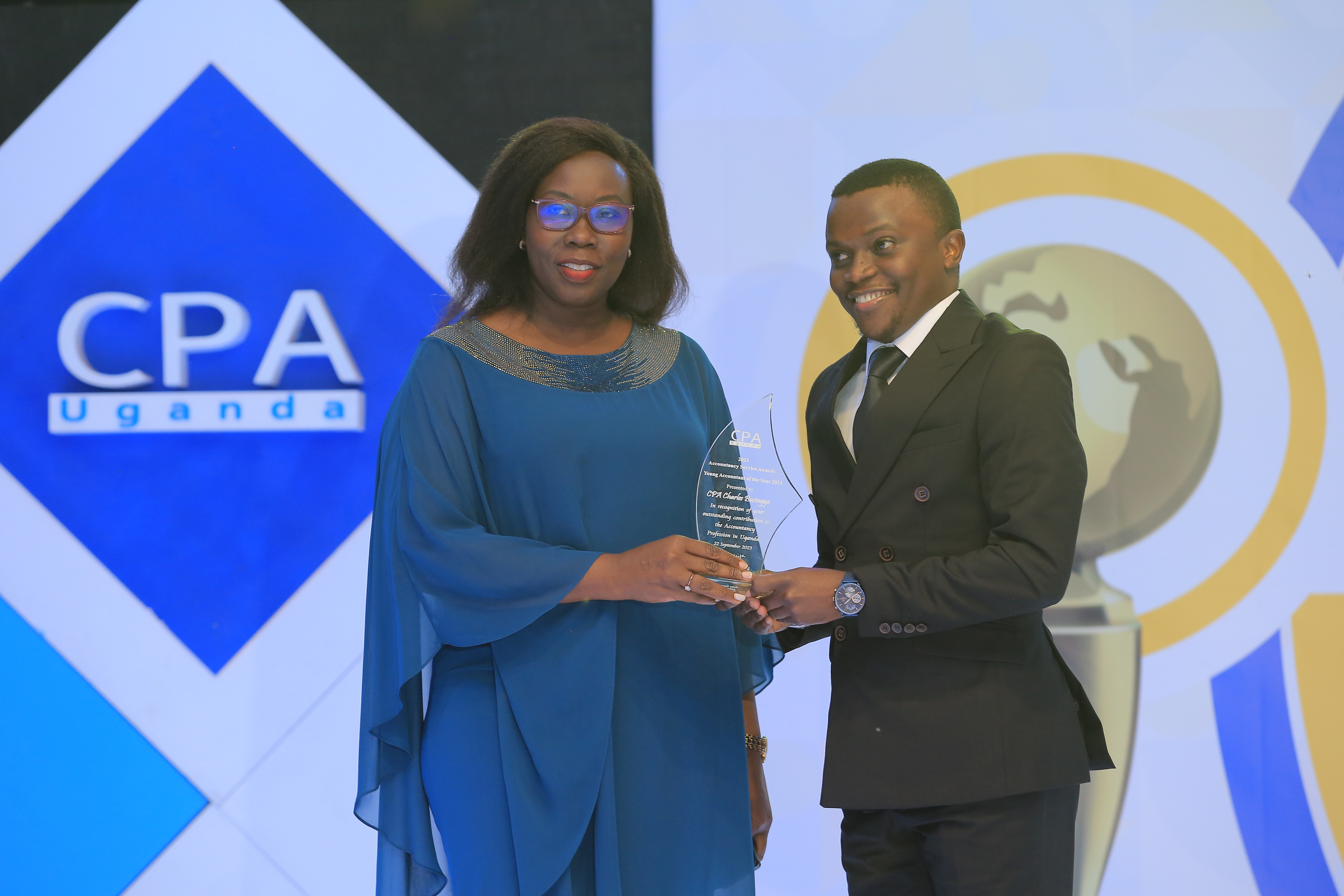 s text will be used by screen readers, search engines, or when the image cannot be loaded. ICPAU President CPA Josephine Okui Ossiya handing the Award to CPA Charles Busingye of Uganda Electricity Generation Company Limited