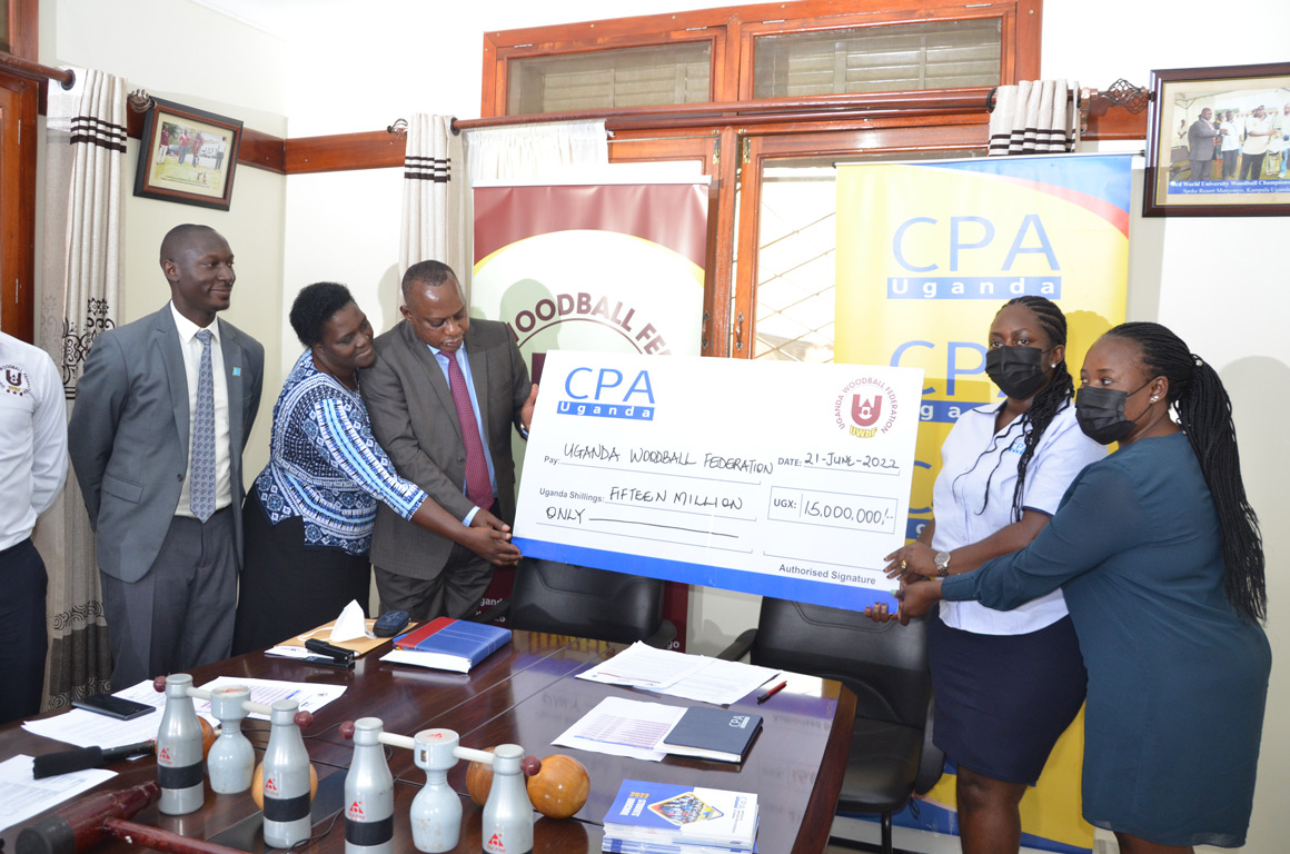 ICPAU officials handing over the cheque to the UWbF team during the unveiling of Junior Woodball championship sponsors
