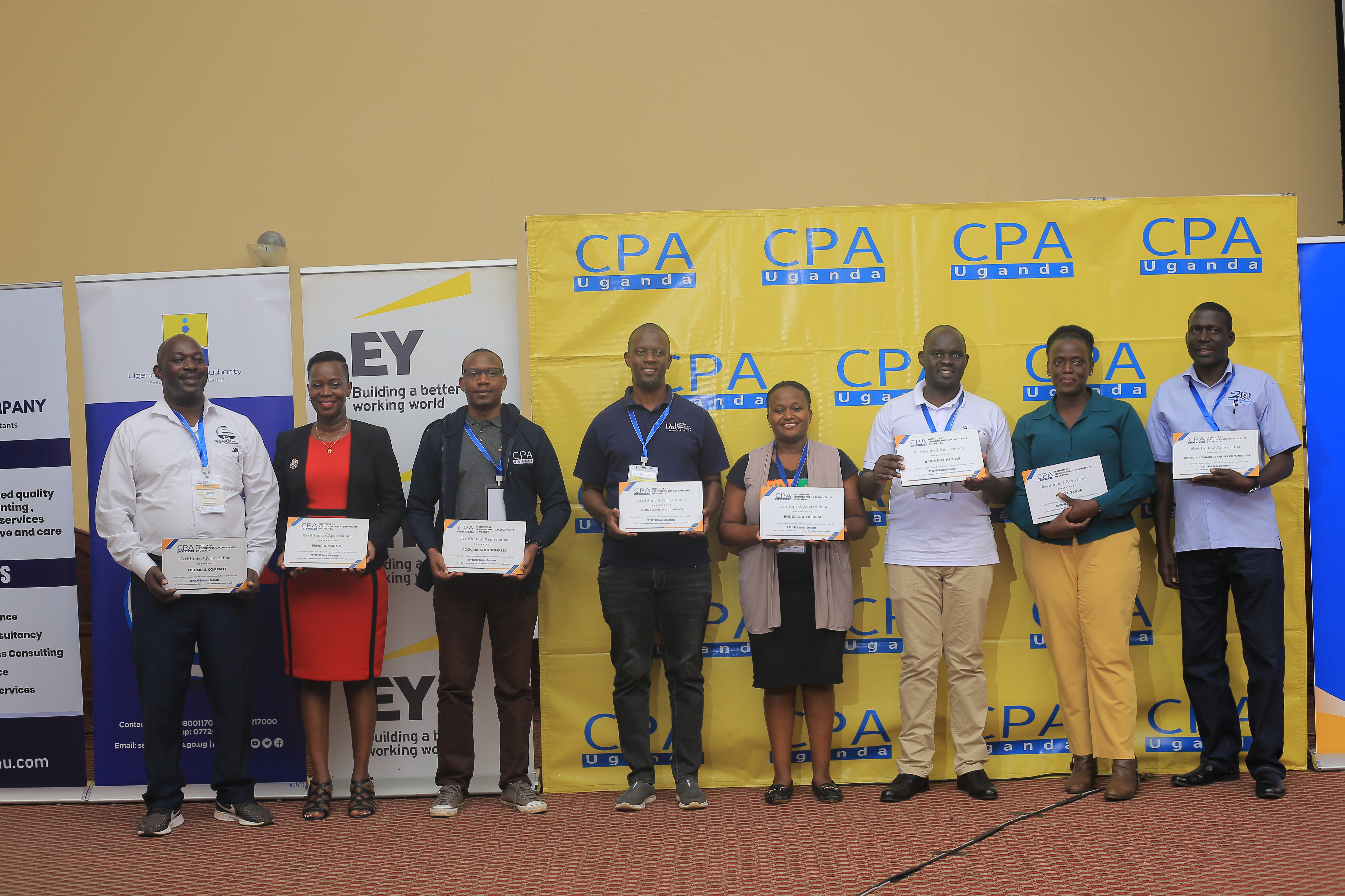 Some representatives of the partners for the 28th Annual Seminar smile for a photo.