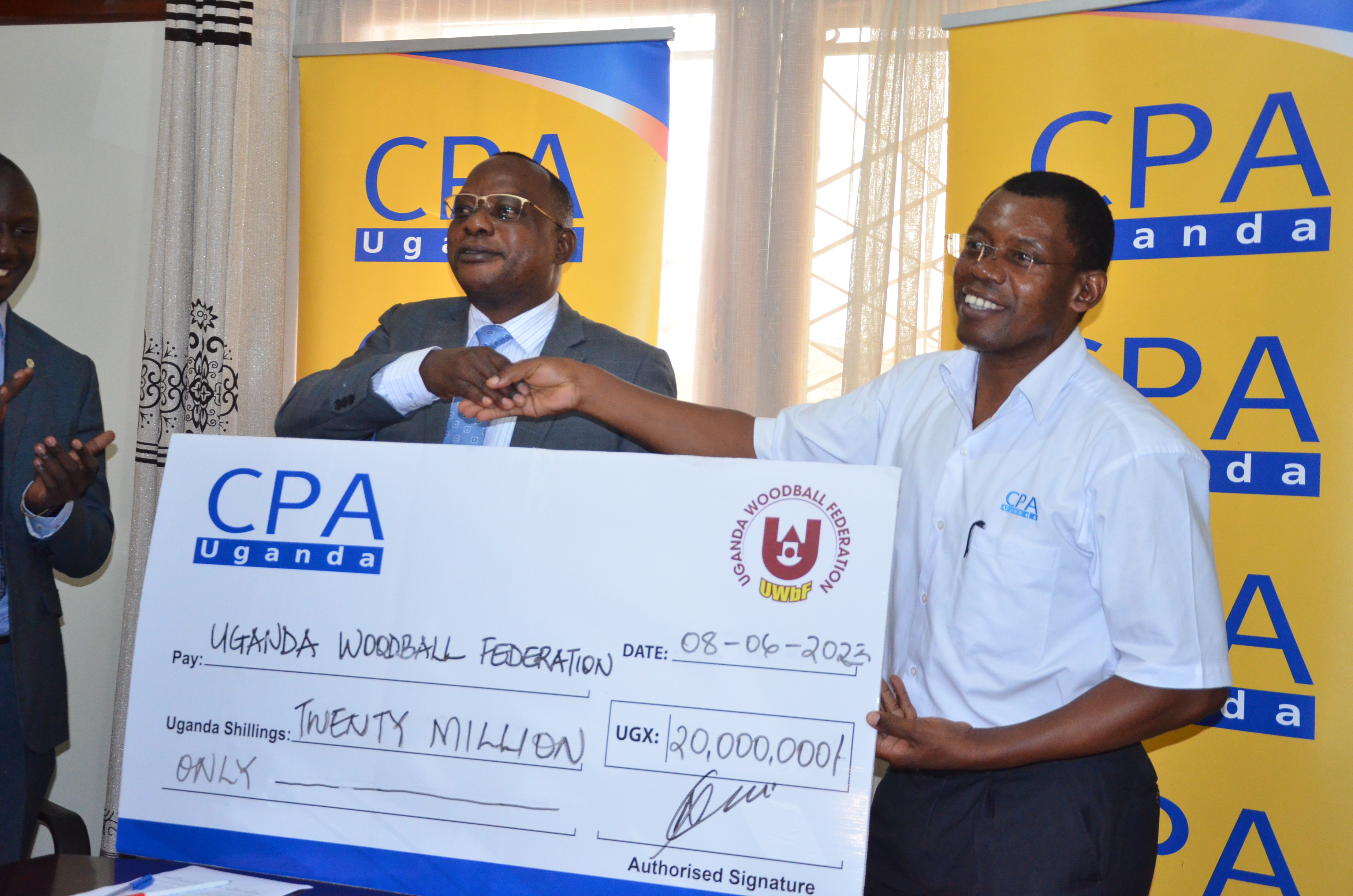The CEO handing over the 20 miilion cheque to the President of the federation